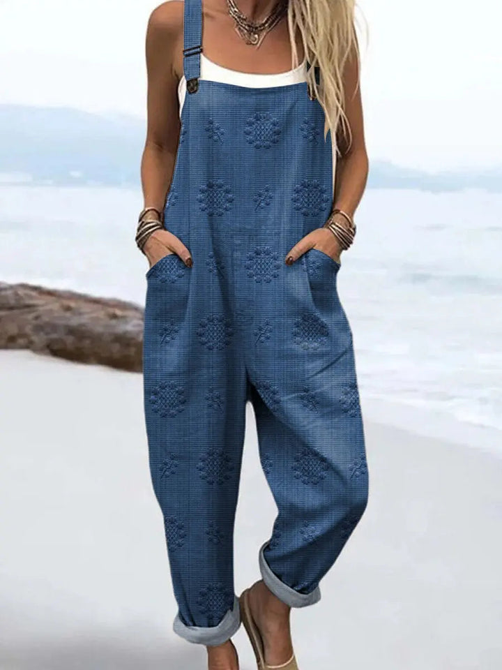 Women's relaxed wide-leg jumpsuit with adjustable straps & side pockets, perfect for casual summer wear.