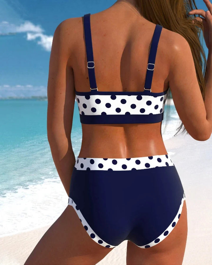 Vintage style women's two-piece polka-dot high-waisted bikini set in navy blue, ideal for summer beach fashion.
