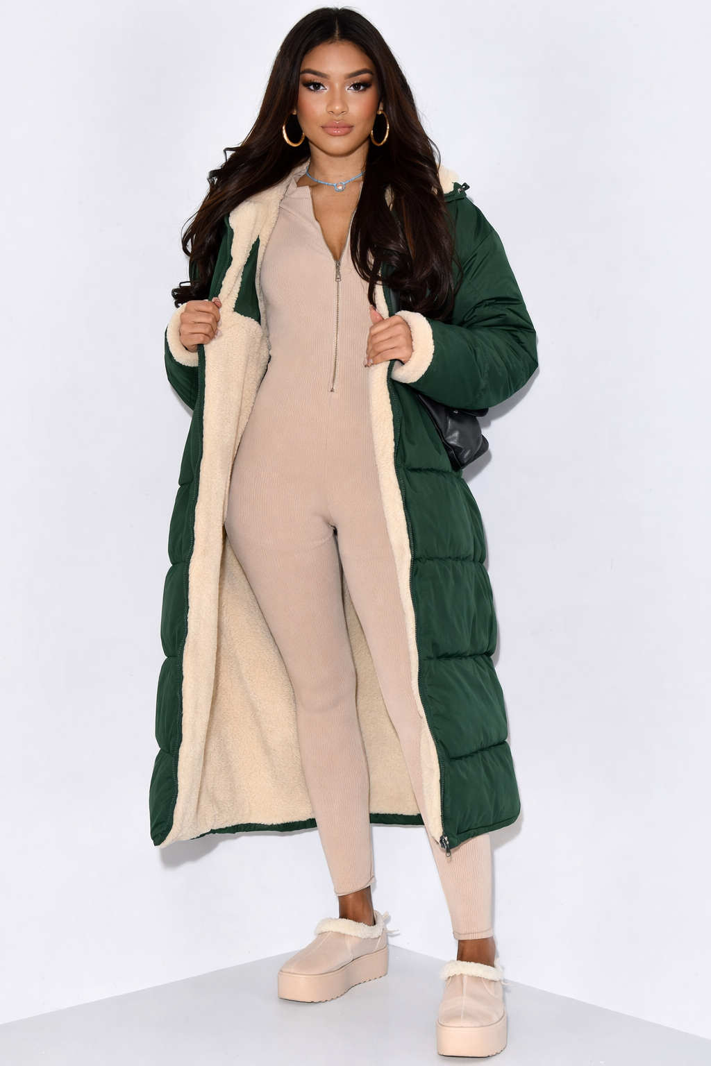 Stylish long women's puffer winter jacket, reversible for two looks, providing extended coverage & warmth.