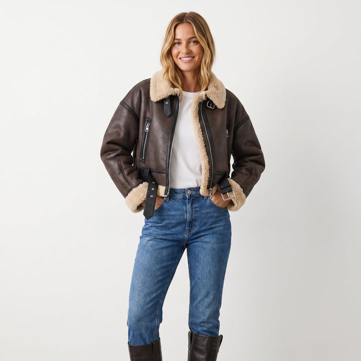 Stylish women's reversible shearling bomber jacket. Chic winter outerwear, a warm and fashionable casual coat.