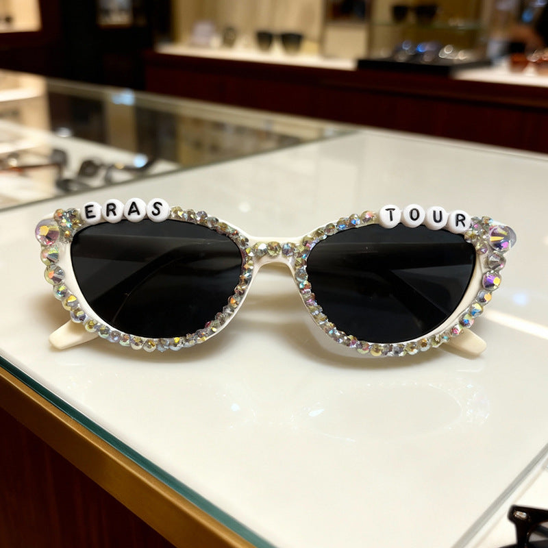 Close-up of women's sparkling rhinestone cat-eye sunglasses, showcasing intricate design and UV protection.
