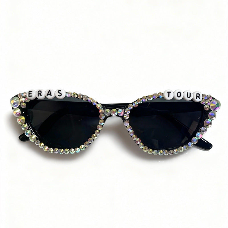 Stylish woman wearing rhinestone cat-eye sunglasses, exuding glamour and sophisticated fashion.