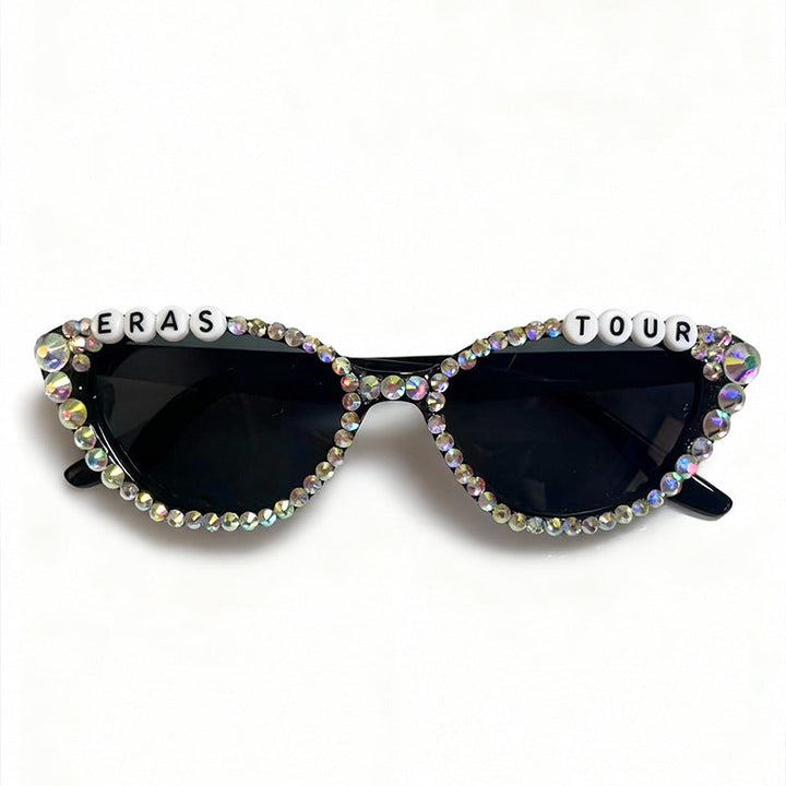 Stylish woman wearing rhinestone cat-eye sunglasses, exuding glamour and sophisticated fashion.