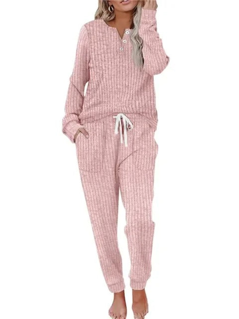 Relaxed women's ribbed loungewear set, ideal for home wear. Two-piece button-neck top & comfy jogger pants.