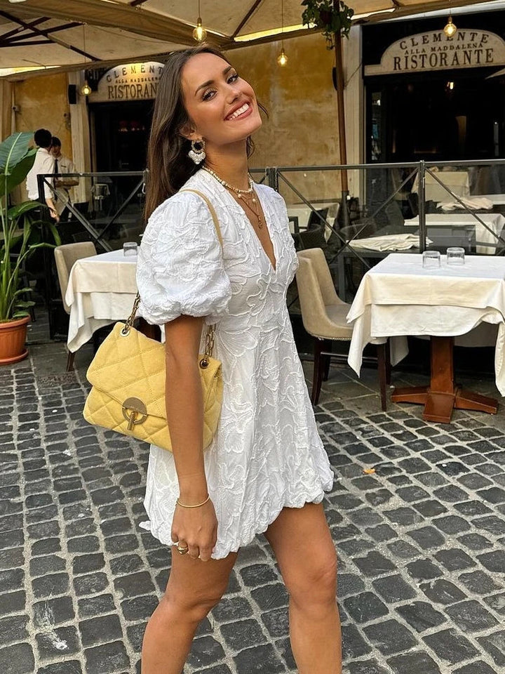 Stylish women's summer mini dress featuring a charming floral print. A versatile and elegant piece for warm weather.