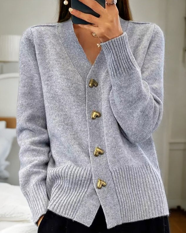 Women's romantic v-neck cardigan with charming heart buttons. Elegant and cozy layering piece for fall fashion.