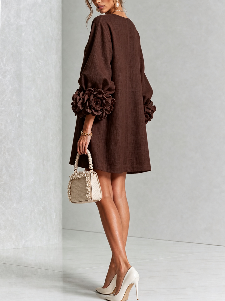 Women's elegant long sleeve mini dress, round neck, with a flowy A-line shift silhouette.