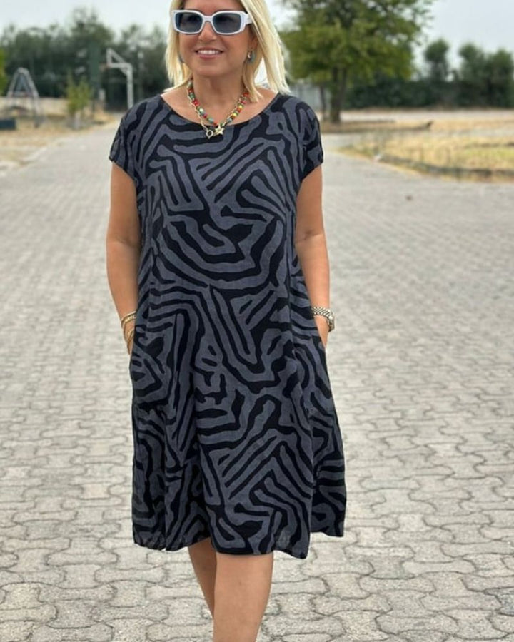 Casual women's round neck summer midi dress. Flowy fabric for a comfortable & chic warm-weather style.