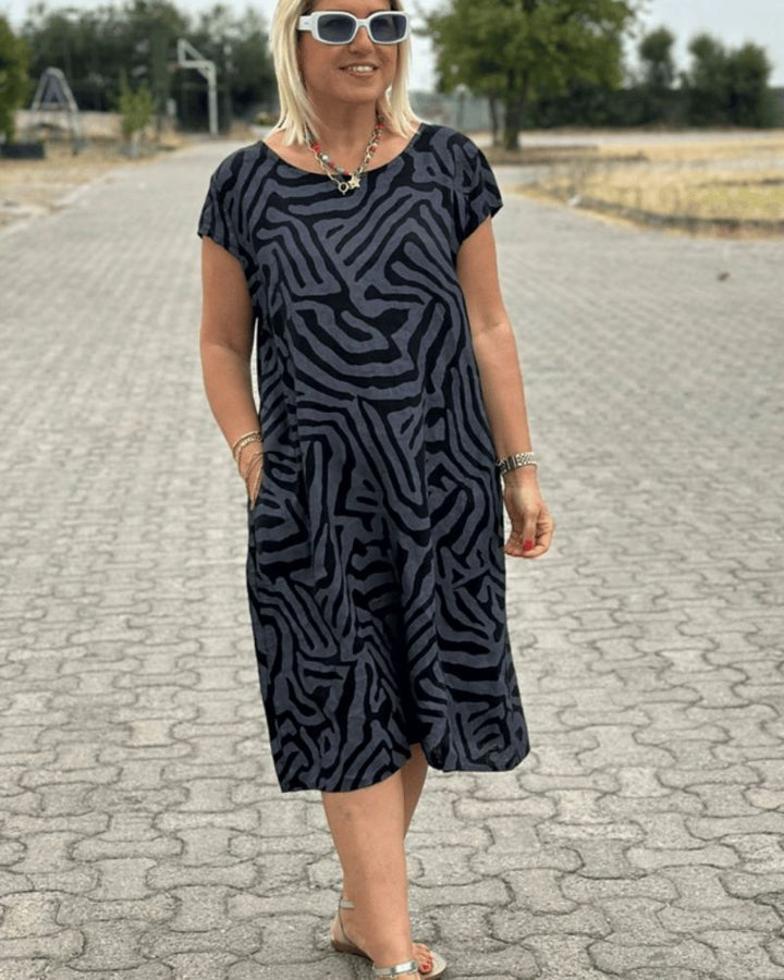 Lightweight women's round neck midi dress. Comfortable summer style, ideal for vacation, beach, or everyday casual.