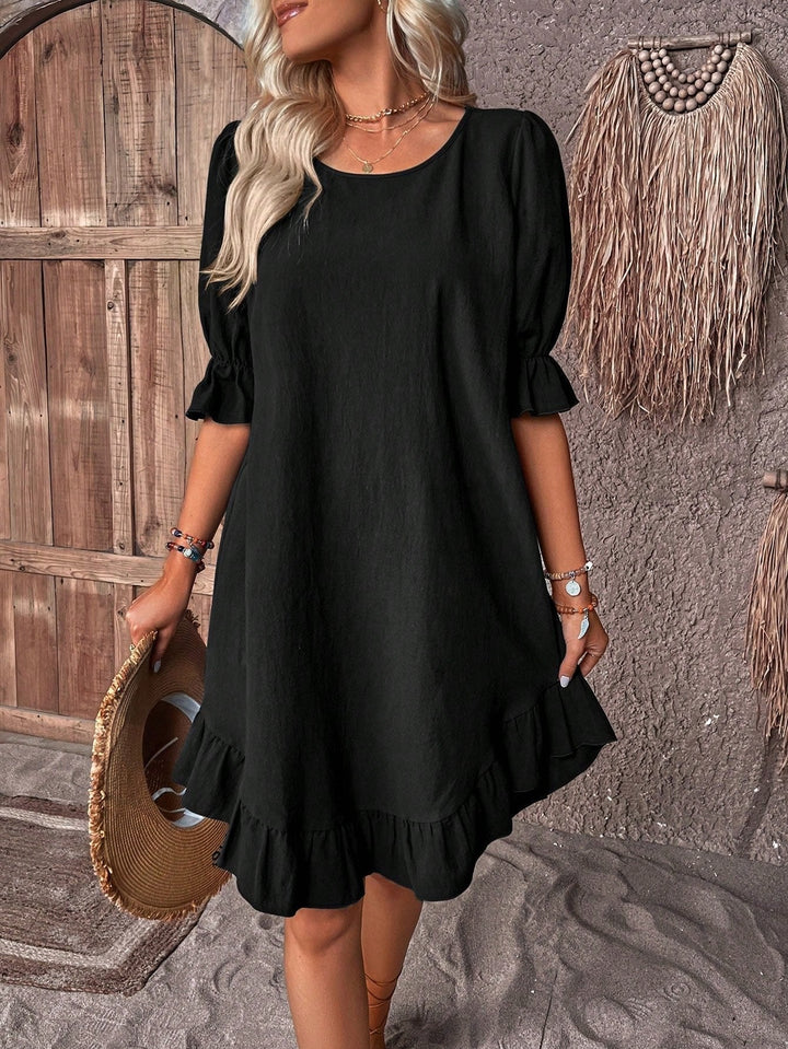 Stylish women's summer mini dress with an A-line silhouette, ruffle hem, & trendy puff sleeves for vacation.