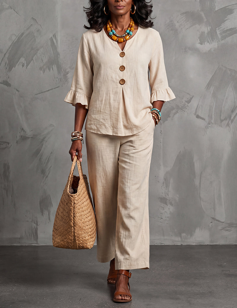 Elegant women's ruffle sleeve top & wide leg trousers outfit set, a modern co-ord for effortless spring fashion.