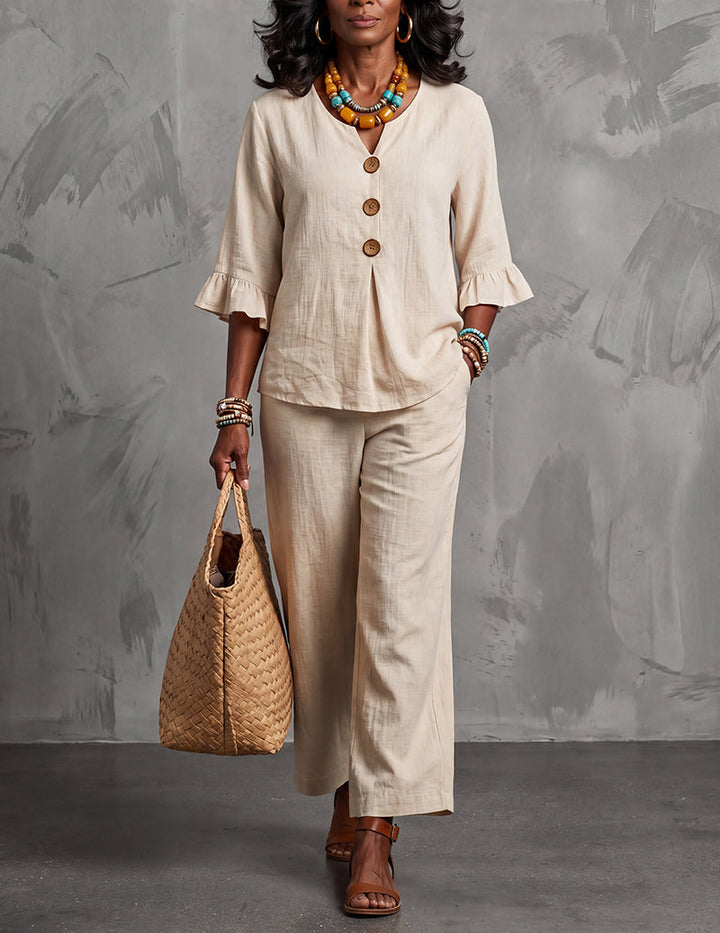 Elegant women's ruffle sleeve top & wide leg trousers outfit set, a modern co-ord for effortless spring fashion.