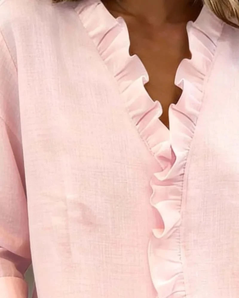 Elegant women's blouse with a ruffle V-neck and long sleeves, designed for a relaxed spring fit.