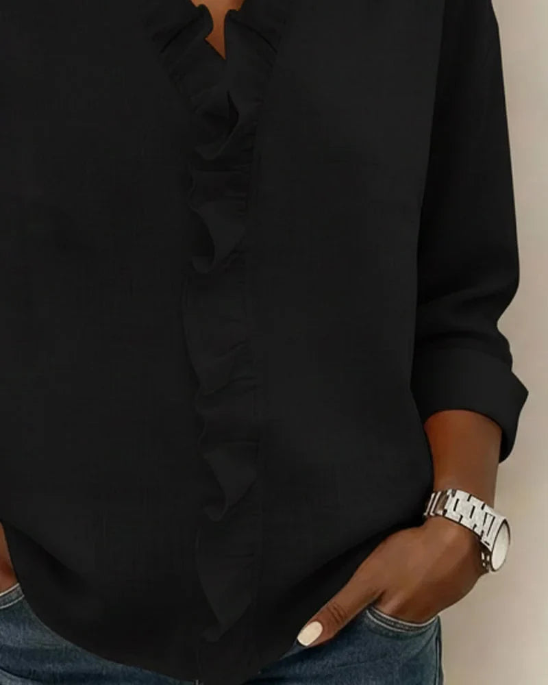 Fashionable women's blouse: ruffle V-neck, long sleeves, relaxed fit, ideal for spring casual elegance.