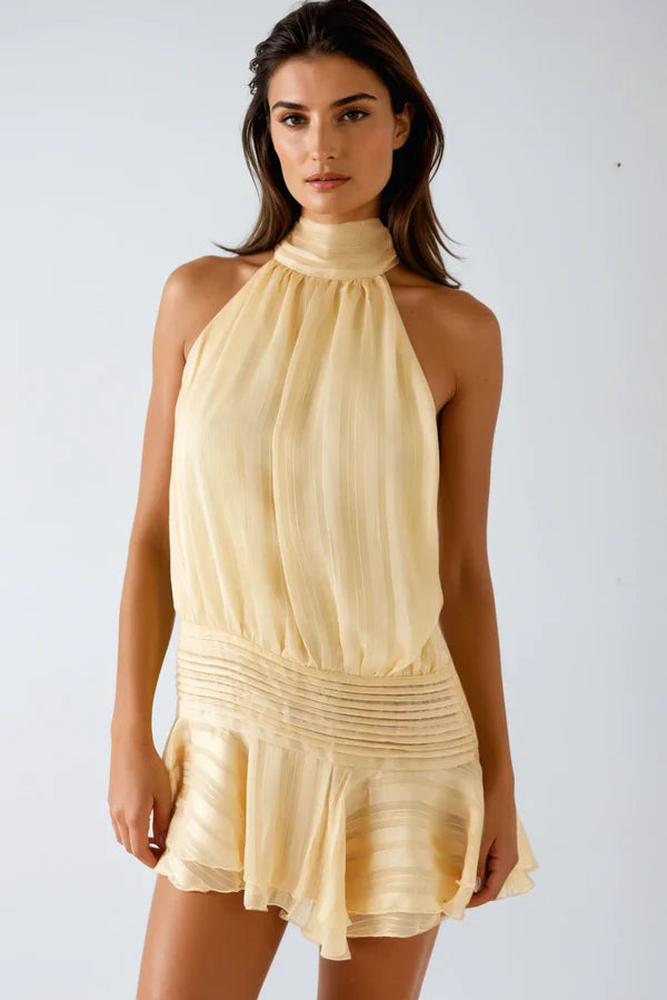 Vibrant yellow ruffled mini halter dress, a flattering and chic party outfit for women.