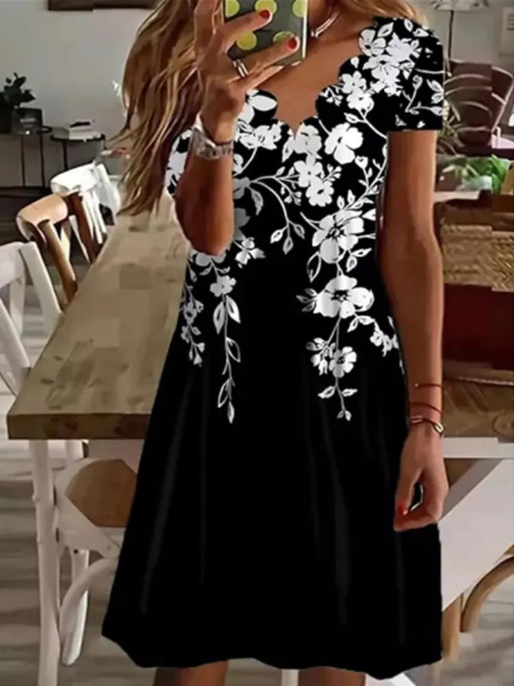 Elegant women's midi dress with unique scalloped neckline & hem, featuring a vibrant floral print.