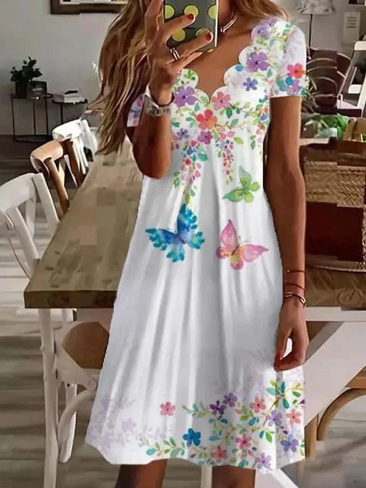 Close-up of a women's floral print midi dress, showcasing a beautiful pattern and soft fabric, ideal for summer.