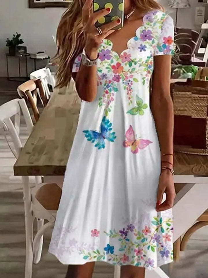 Close-up of a women's floral print midi dress, showcasing a beautiful pattern and soft fabric, ideal for summer.