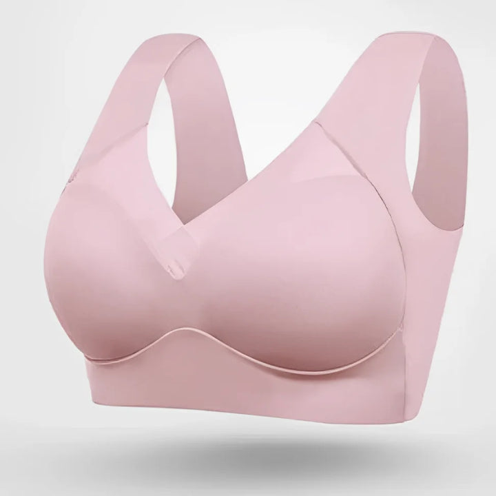 Model wearing a seamless V-neck bra with wide pullover straps, ideal for lounge & full support.