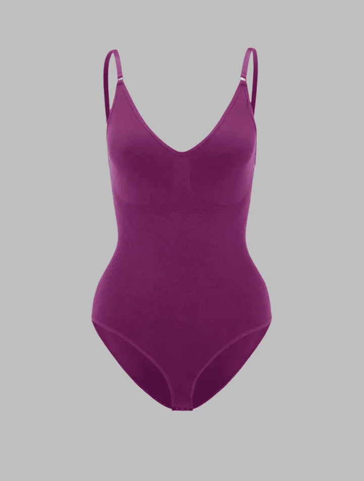 Woman modeling a seamless V-neck shapewear bodysuit, showcasing its slimming effect & comfort.