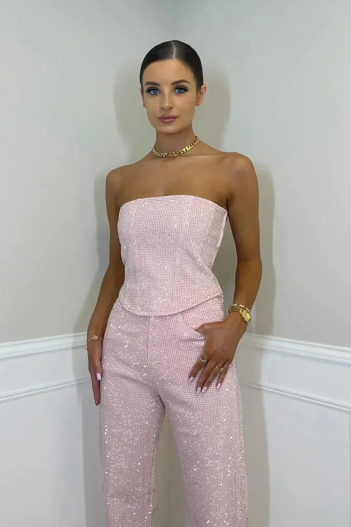 Sparkling pink sequin ensemble: strapless corset and flowing wide leg pants for a festive celebration.