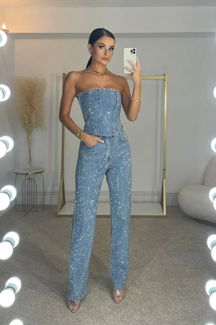 Model wearing a dazzling sequin strapless corset and elegant wide leg pants for an evening event.