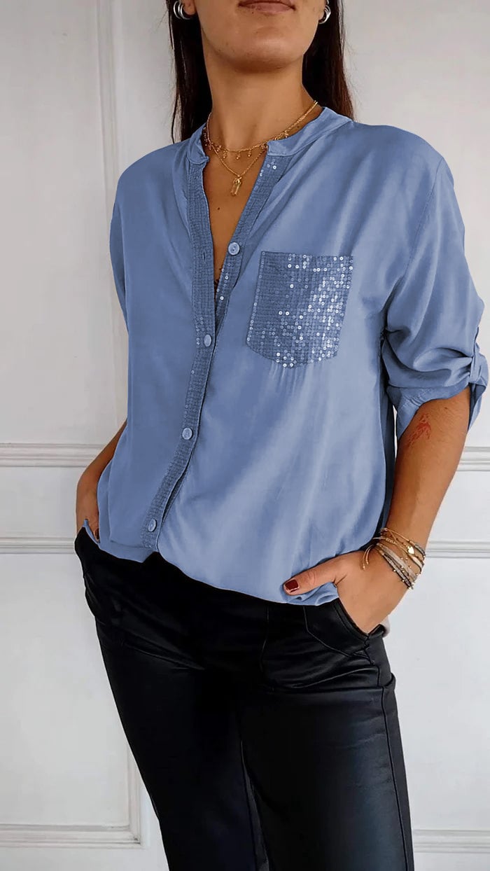 Stylish women's button-up shirt, featuring sequin trim for a sophisticated and shimmering look.