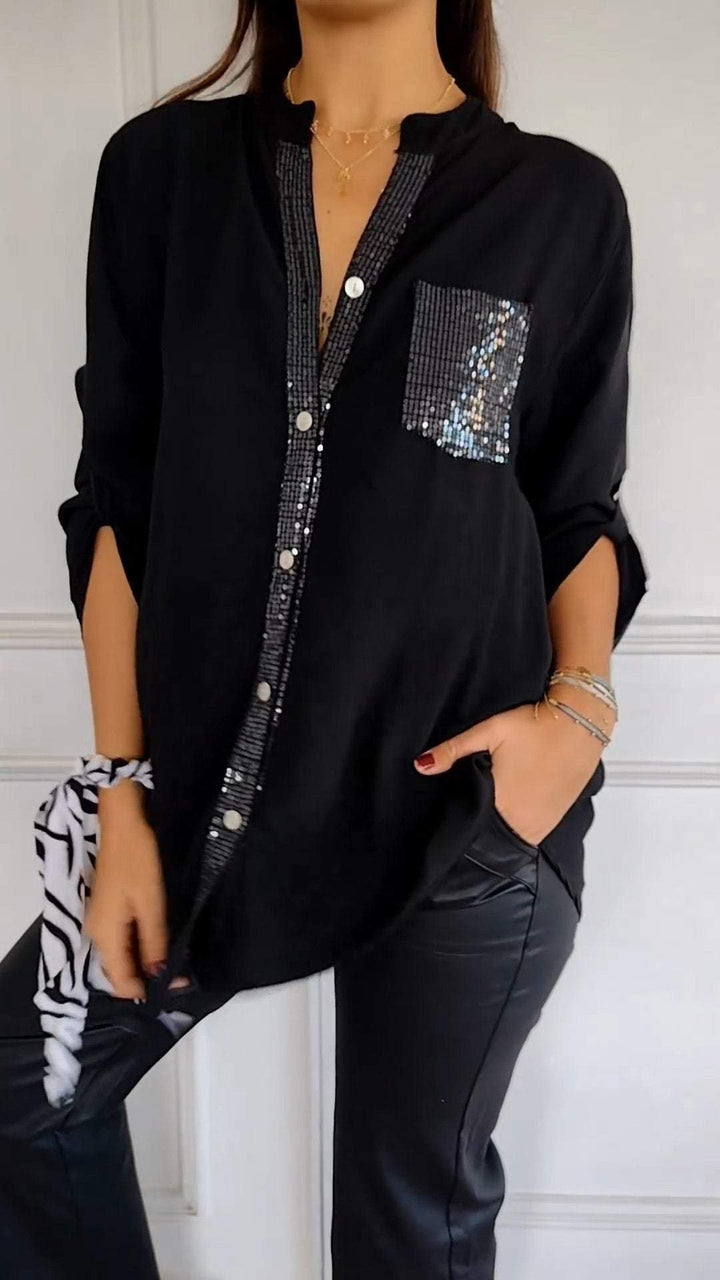 Model wearing a women's sequin trim button-up shirt, styled elegantly for a casual chic look.