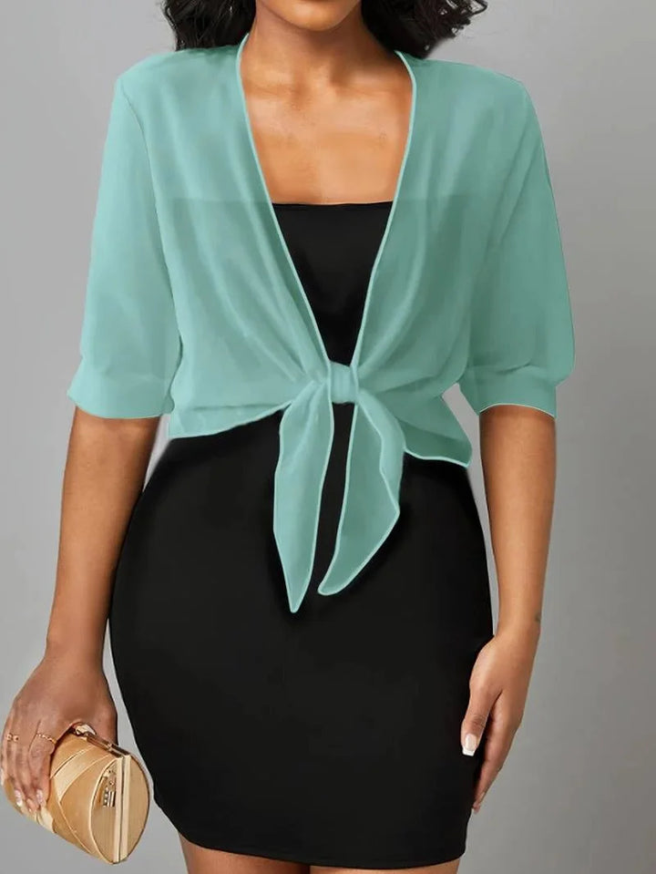 Stylish women's sheer tie-front top with 3/4 sleeves, perfect for a casual summer outfit.