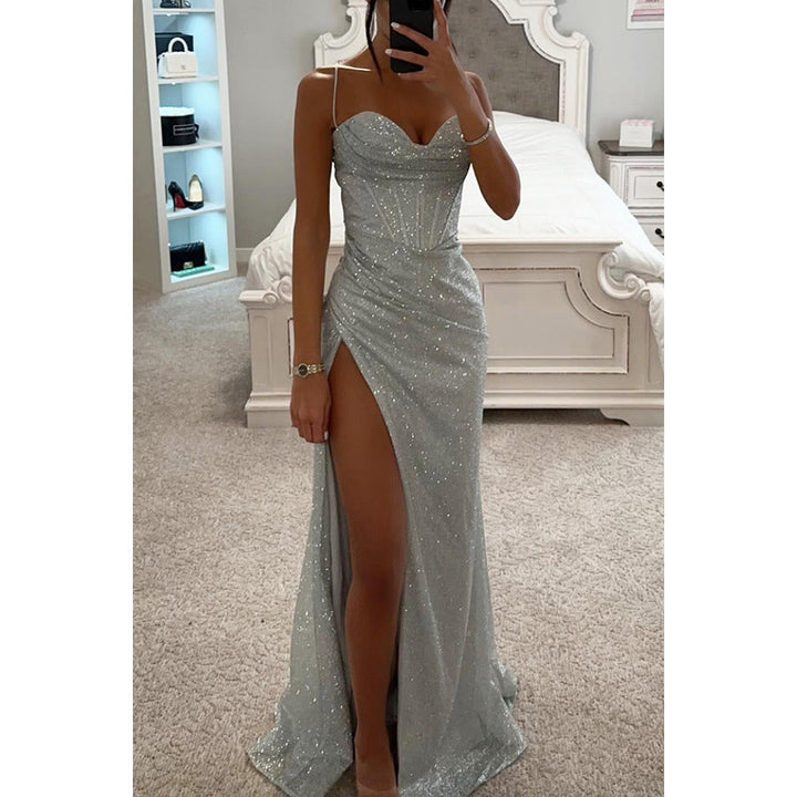 Sleeveless women's glittering maxi dress. Elegant long evening gown with a flattering split hem for parties.