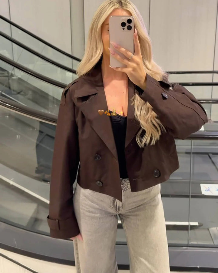 Short double-breasted women's trench coat in coffee. Classic elegant transitional outerwear for smart casual layering.