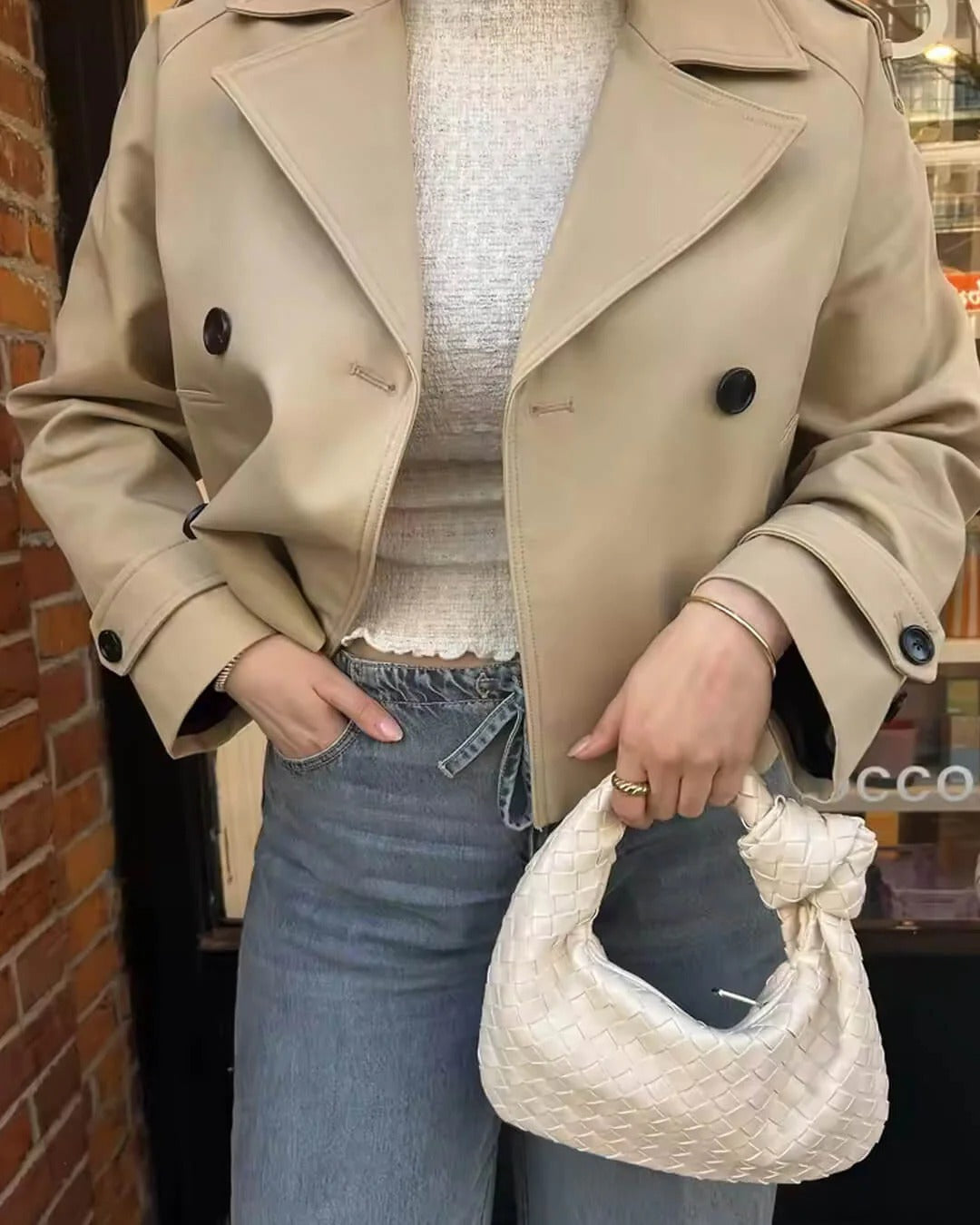 Khaki short double-breasted trench coat for women. Stylish transitional jacket, perfect for layering and fashion.