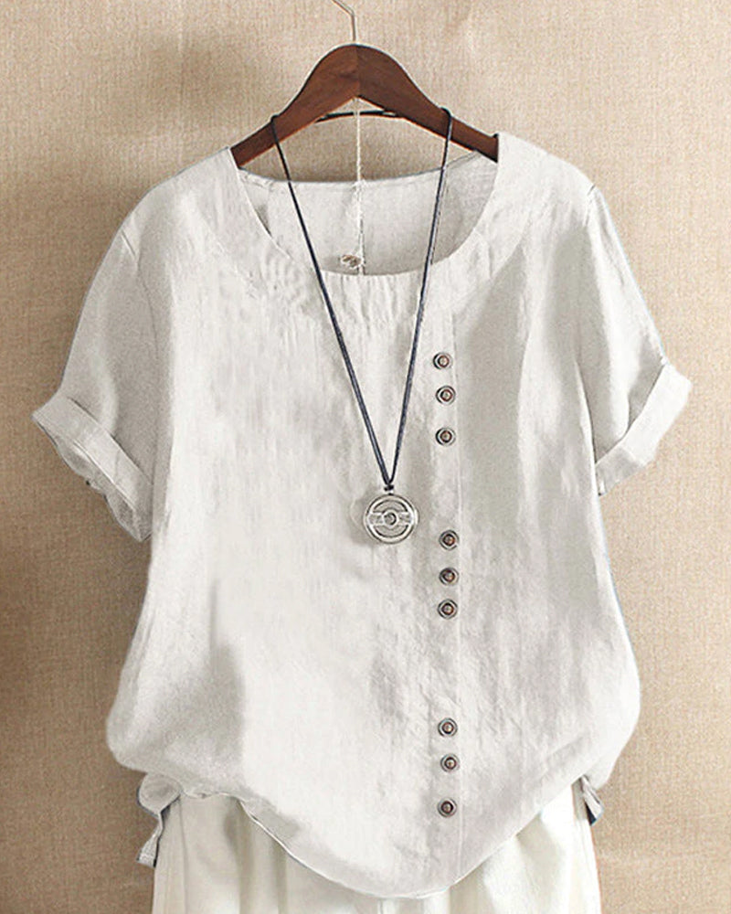 Chic women's relaxed fit short sleeve blouse, featuring stylish button details for versatile warm weather fashion.