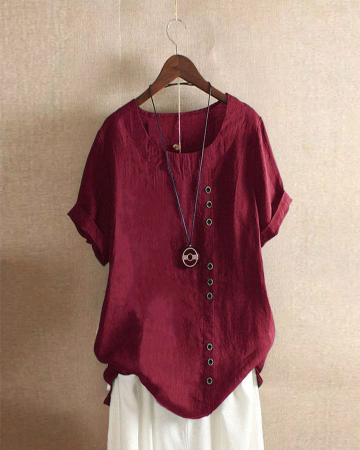 Effortless style women's short sleeve blouse, featuring decorative button details for a chic and relaxed summer top.