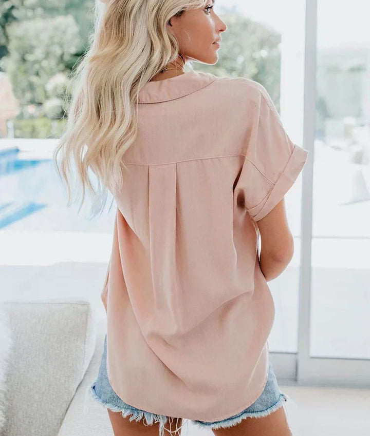 Casual women's short sleeve top with a smart collar and two front pockets. Perfect for summer comfort.