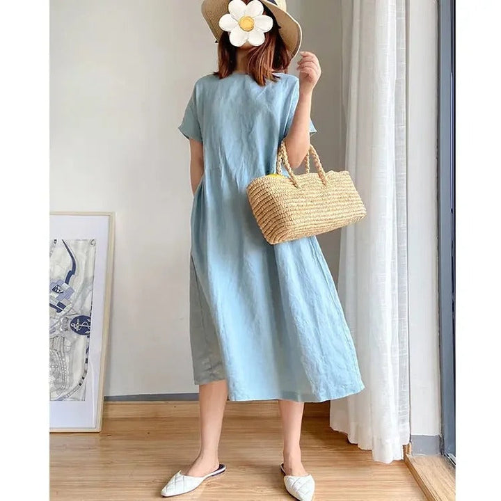 Effortless women's short sleeve linen midi dress with practical pockets. Casual, relaxed, perfect for summer comfort.