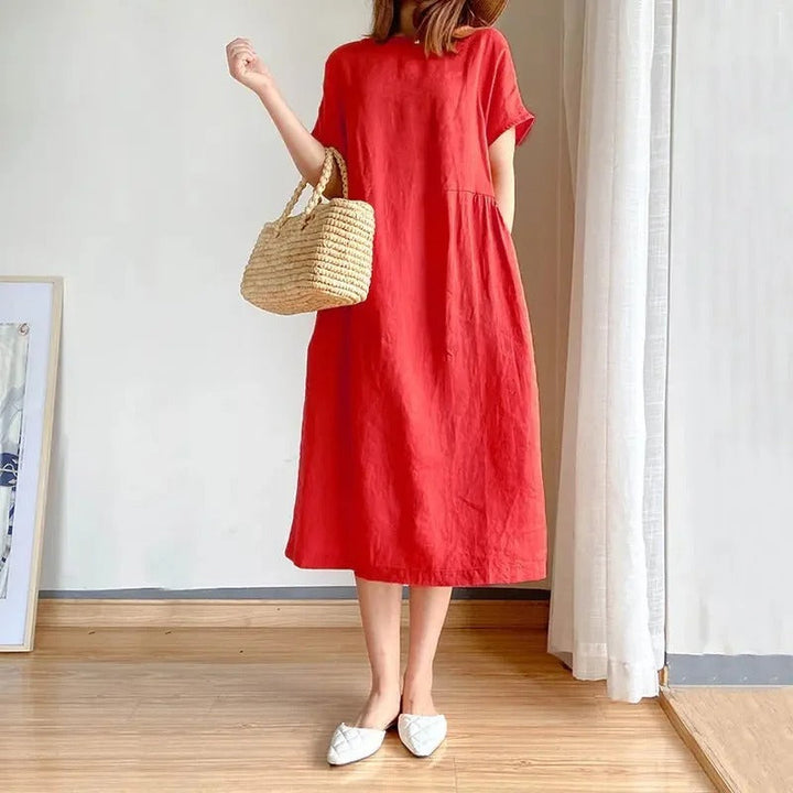 Relaxed fit women's short sleeve linen midi dress with pockets. Comfortable, versatile, perfect for everyday summer outfits.