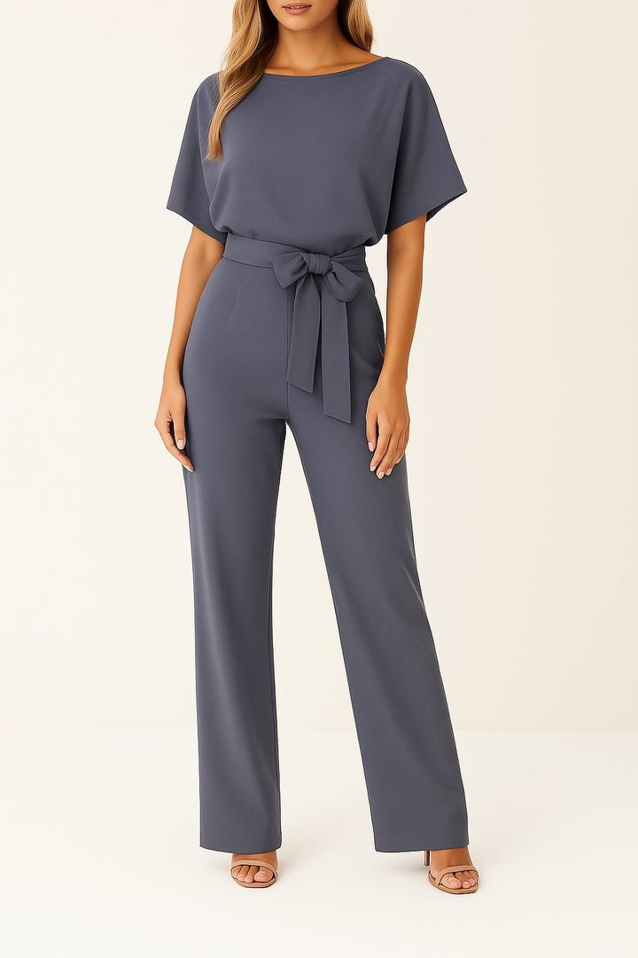 Chic women's one-piece wide-leg jumpsuit, short sleeves & belt detail for modern, comfortable fashion.