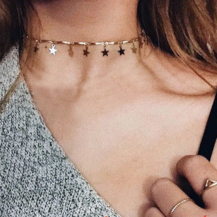 Women's silver tone celestial star charm linked chain necklace, adjustable and stylish fashion accessory.