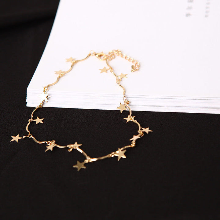 Delicate women's linked chain necklace with multiple celestial star charms in shining silver tone finish.