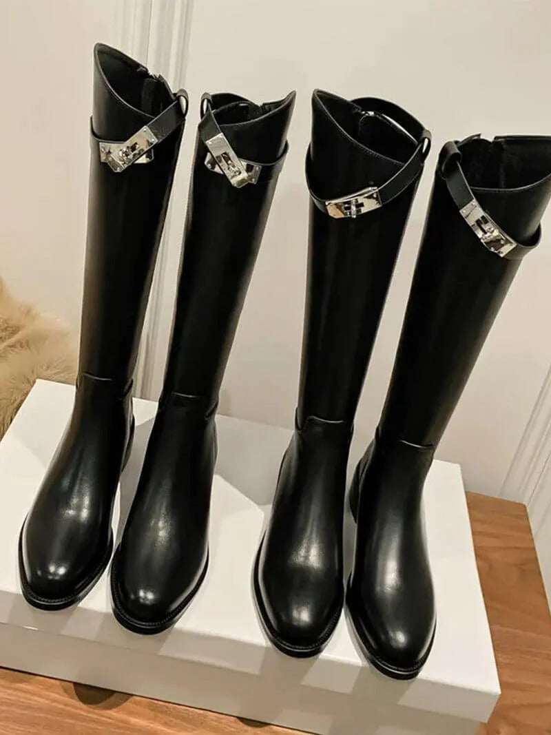 Black sleek knee-high boots for women. Fashionable, elegant, and versatile tall winter footwear.