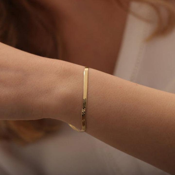 Women's sleek gold snake chain bracelet, adjustable and elegant, a perfect fashion accessory.