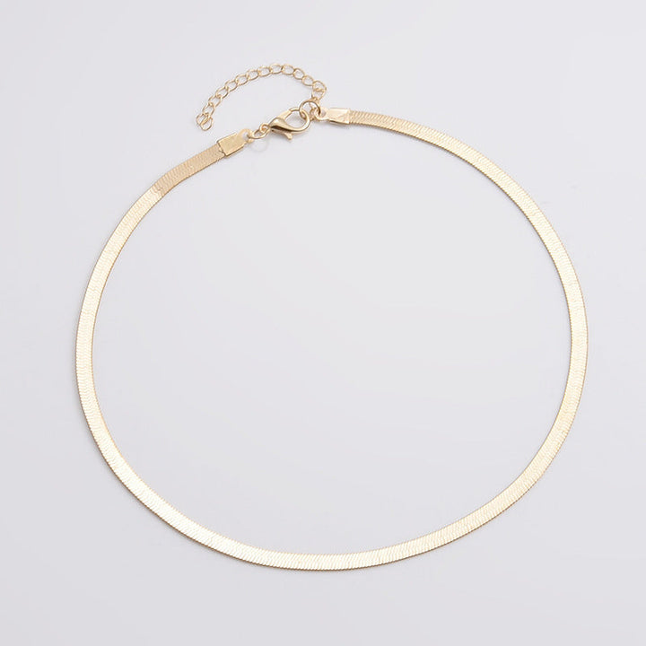 Sleek gold snake chain necklace. Women's elegant minimalist jewelry, a timeless fashion accessory.