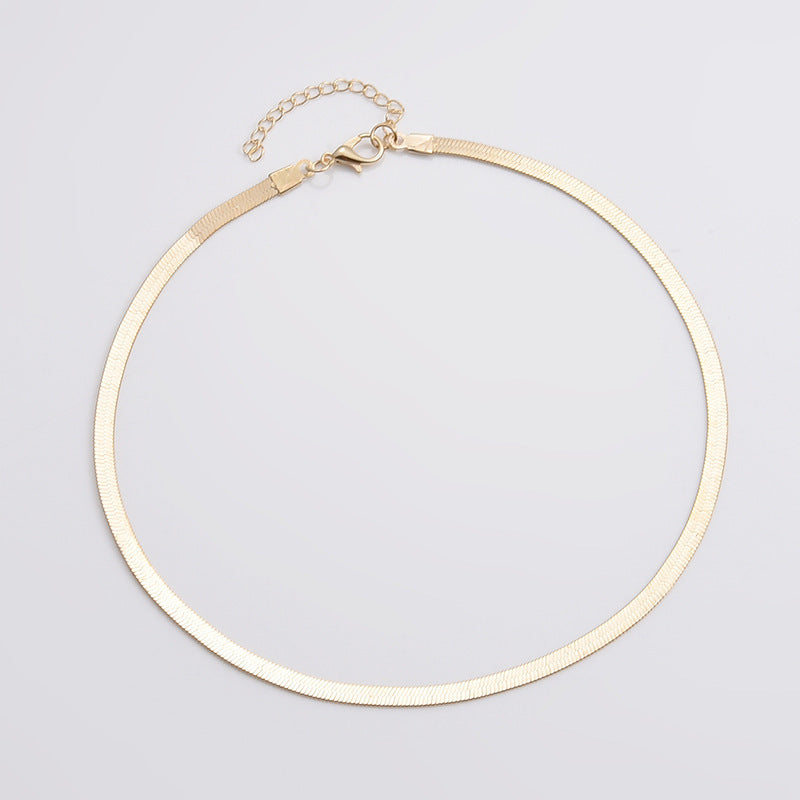 Versatile women's gold snake chain necklace. Perfect minimalist fashion accessory for layering or solo wear.