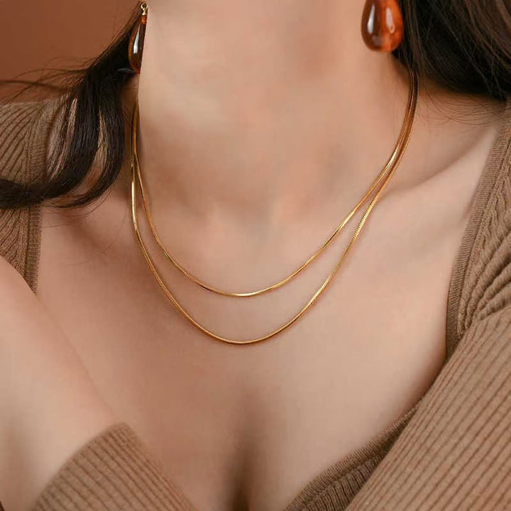 Fashionable layered chain necklace for women, featuring a sleek gold and silver-tone design, perfect statement piece.