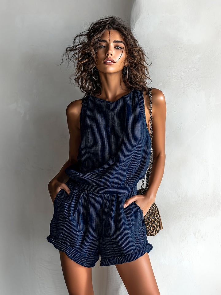 Women's sleeveless boat-neck romper with pockets, ideal for summer travel and casual elegance.