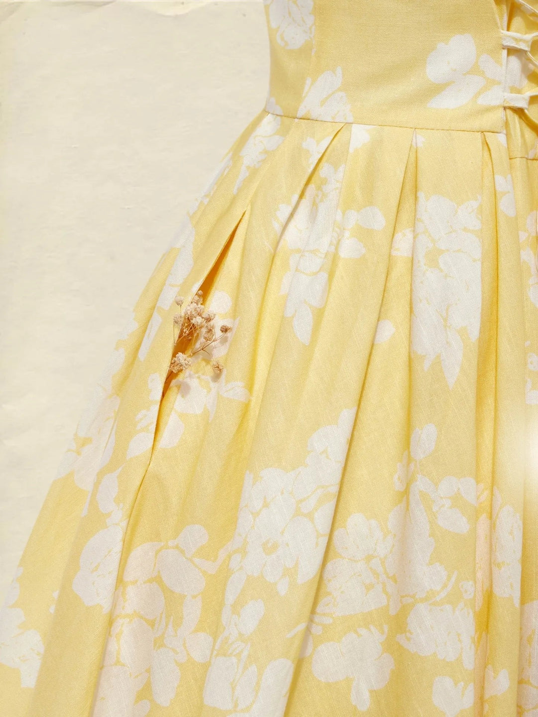 Back view of a women's sleeveless floral A-line midi dress, showing the flowing skirt.