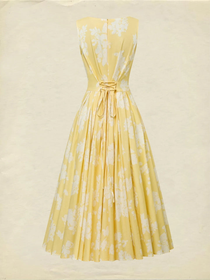 Woman seated, showcasing the elegant flow of a sleeveless floral A-line midi dress.