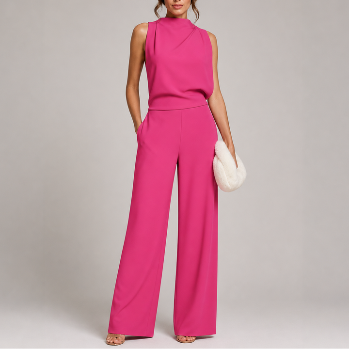 Fashionable woman wearing a black sleeveless mock neck wide-leg formal jumpsuit, suitable for wedding guests.