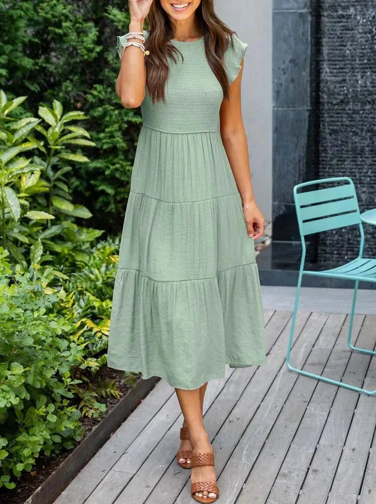 Women's sleeveless smocked midi dress, perfect for effortless summer style & vacation.